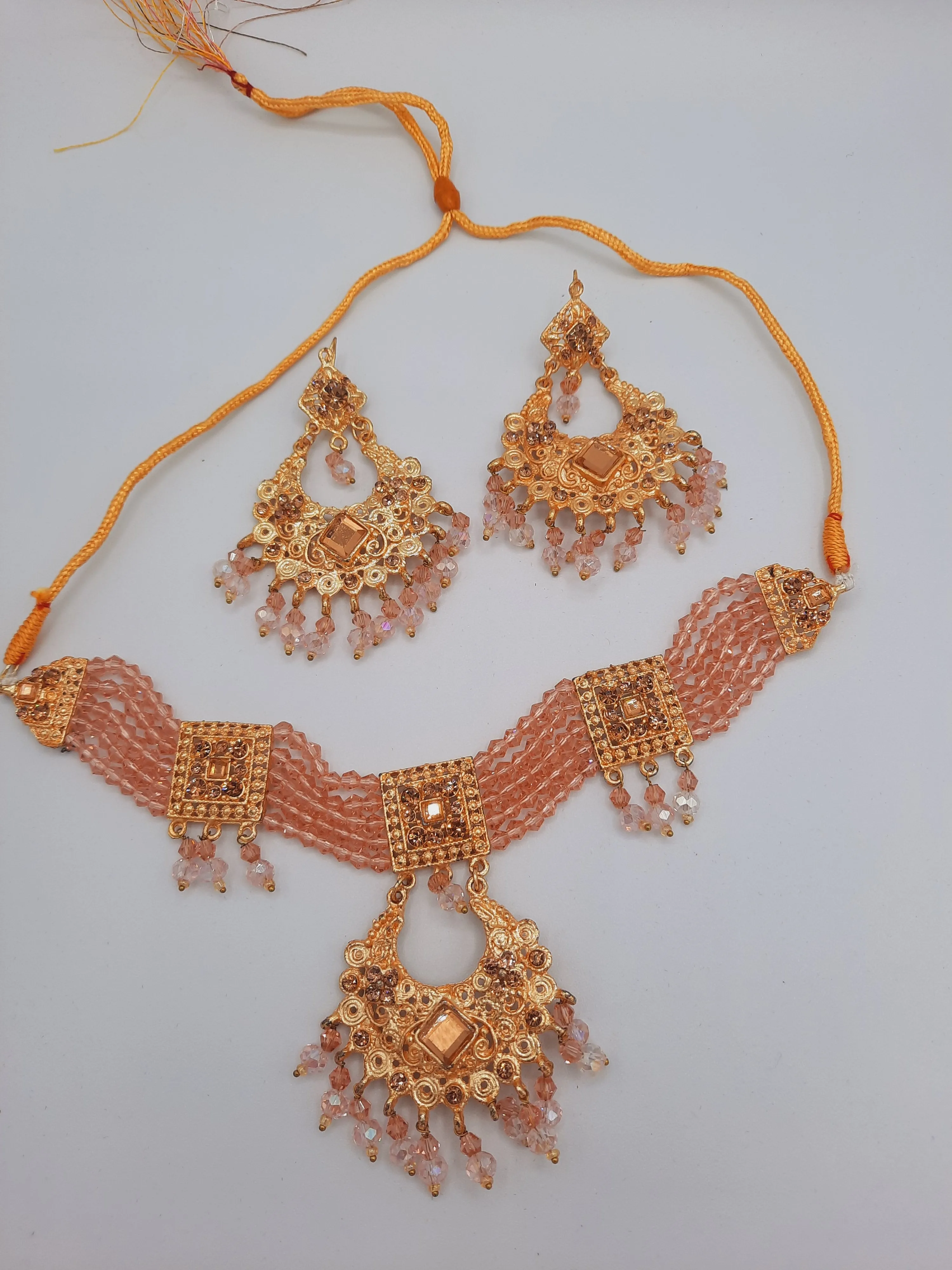 Pink guluband choker with earrings and teeka